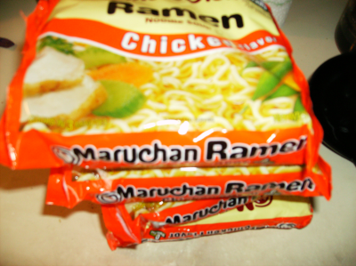 Four chicken ramen packets open